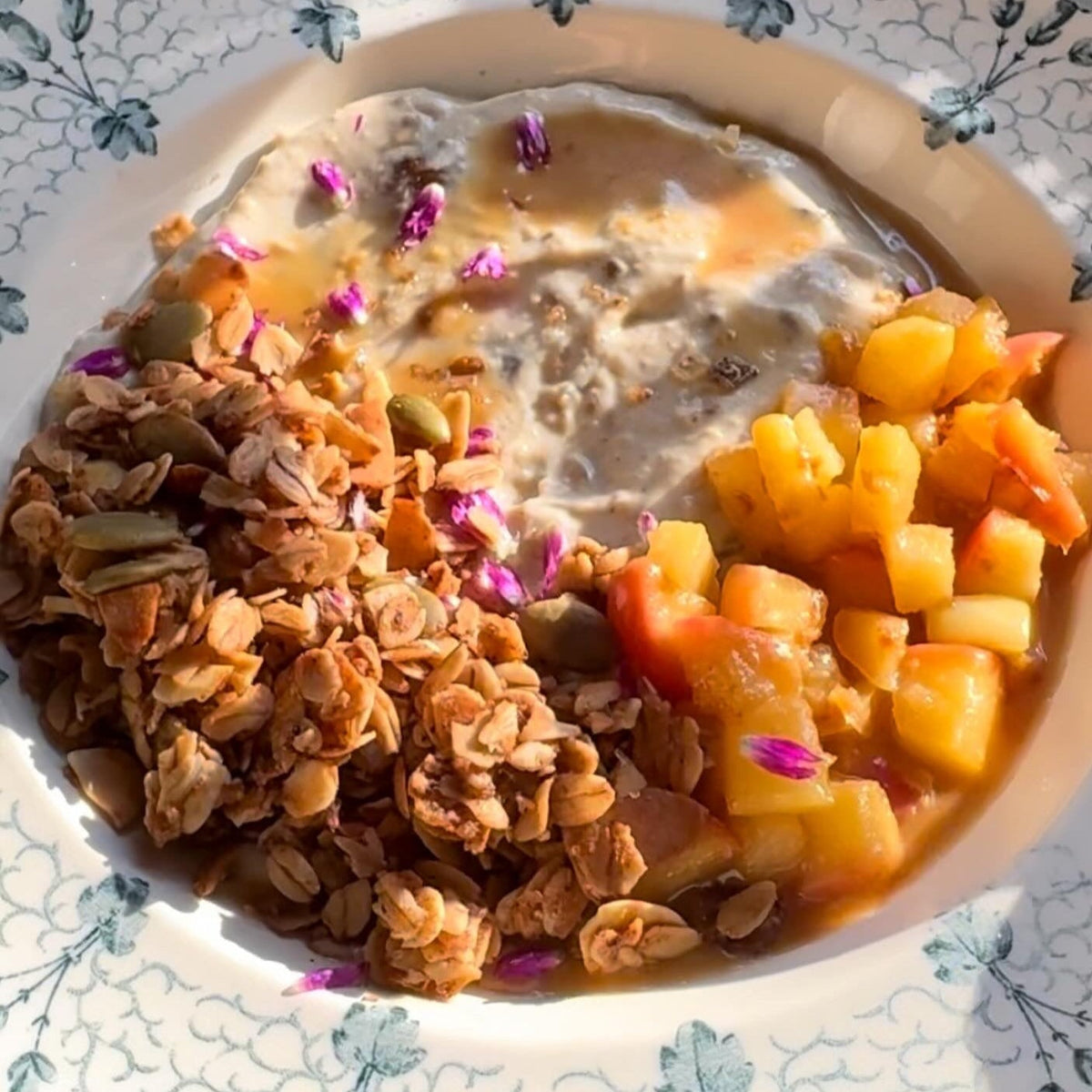 Chai Streusel Granola in a bowl with fruit and milk